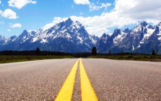 Long Road Headed towards Snowy Mountains